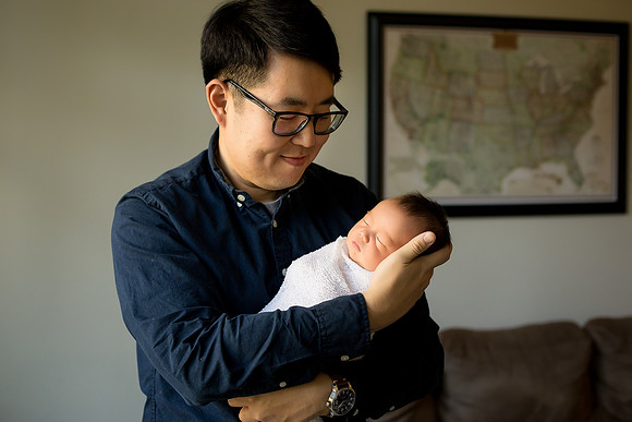 Father cradles his baby son