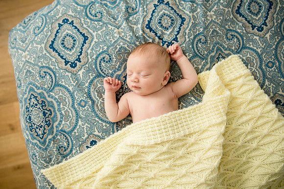 Baby boy with yellow blanket.